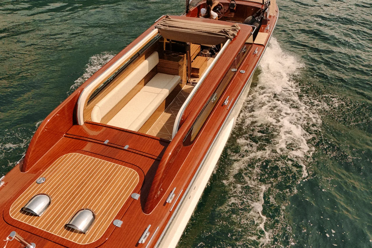 Close view of the polished wood deck and the teak detailing on board.